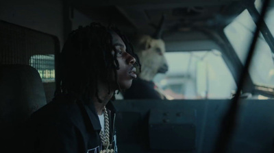 a man with dreadlocks sitting in a car