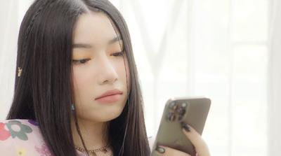 a young woman looking at her cell phone