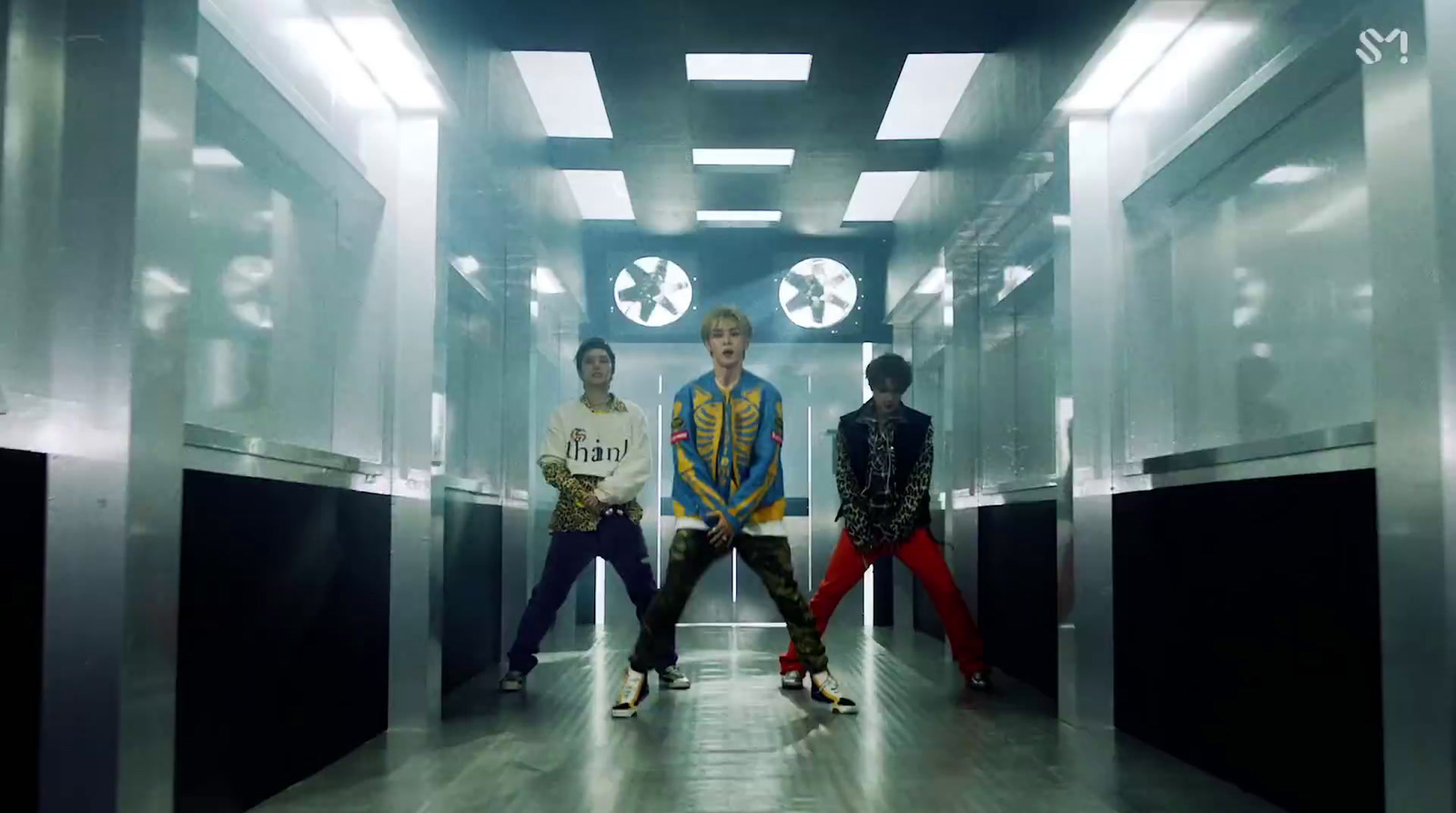 a group of young men standing in a hallway