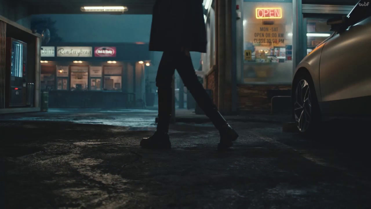 a person walking down a street at night