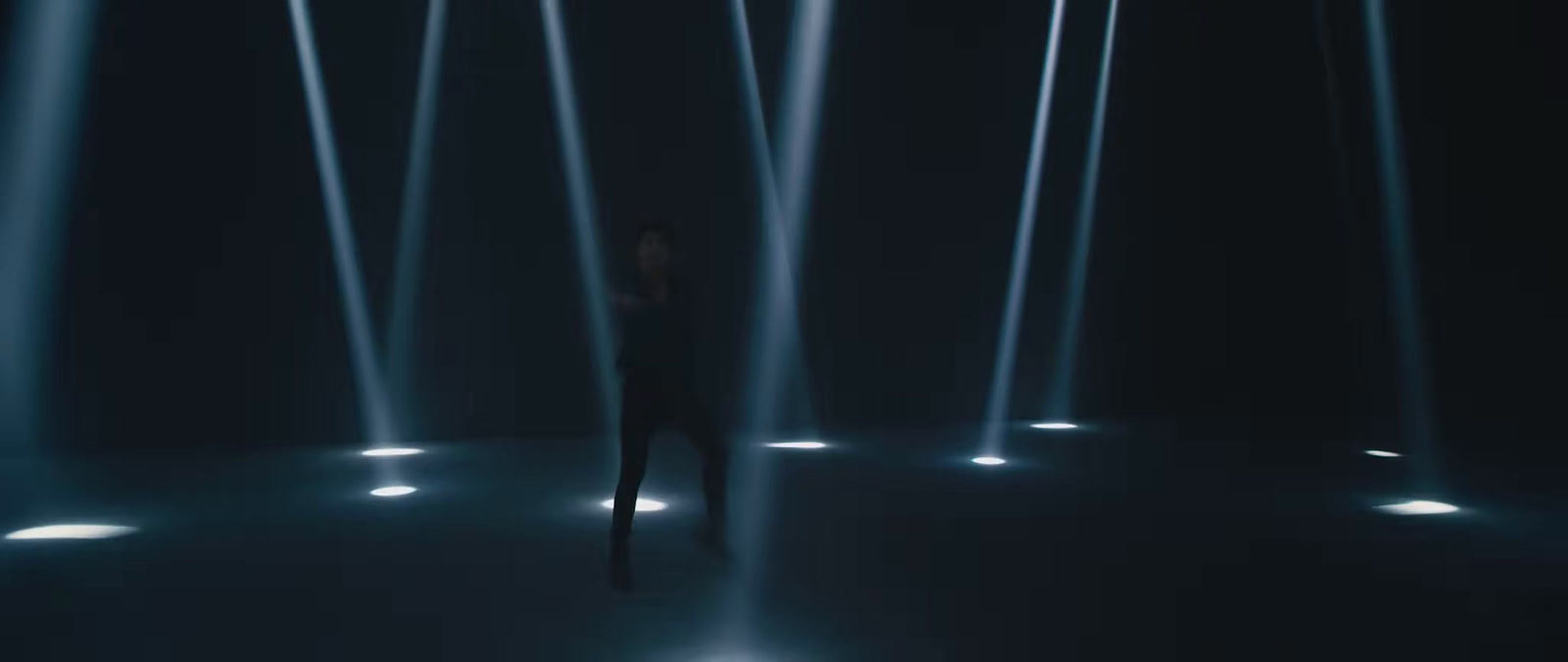 a woman standing in front of a row of lights