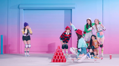 a group of young women standing on top of a skateboard