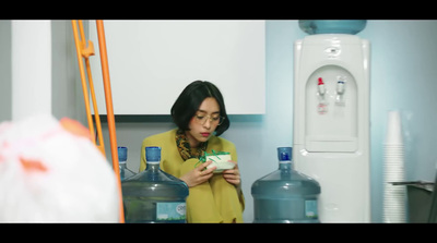 a woman standing in a kitchen holding a bowl