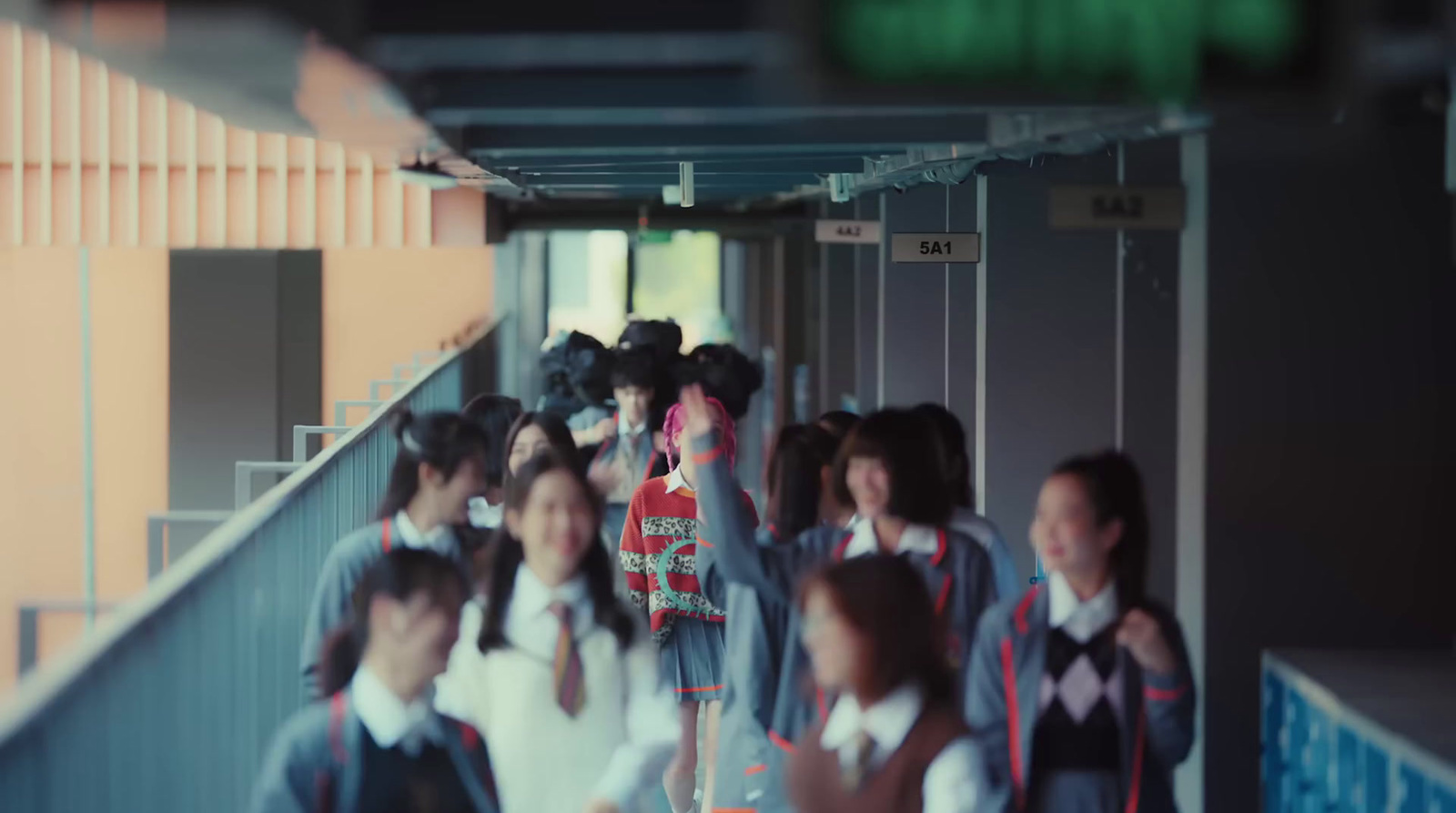 a group of people walking down a hallway