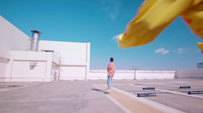 a man riding a skateboard across a parking lot