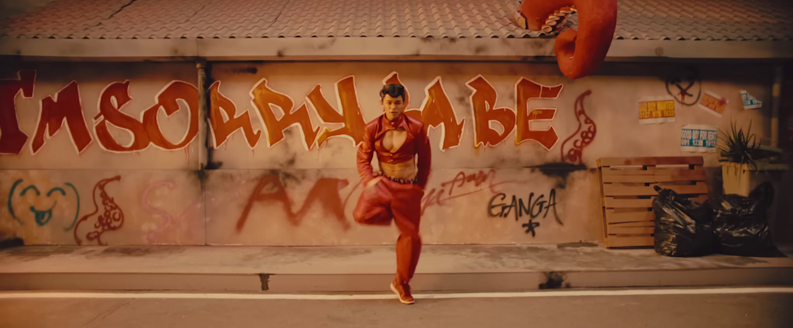 a woman standing in front of a graffiti covered wall