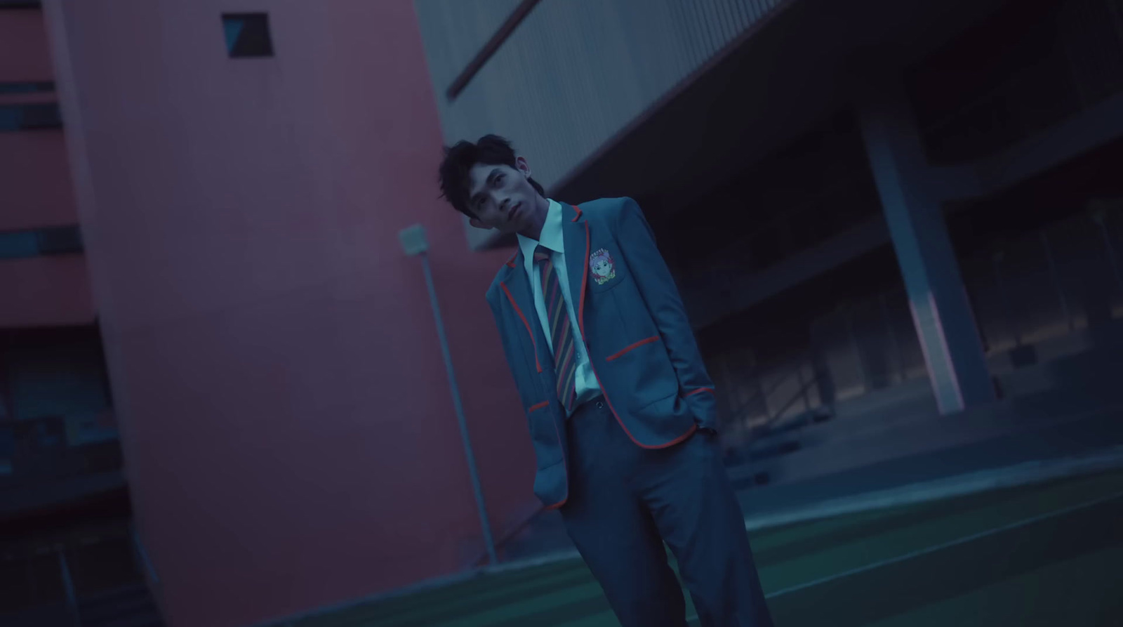 a man in a suit and tie standing in front of a building