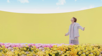 a woman standing in a field of flowers