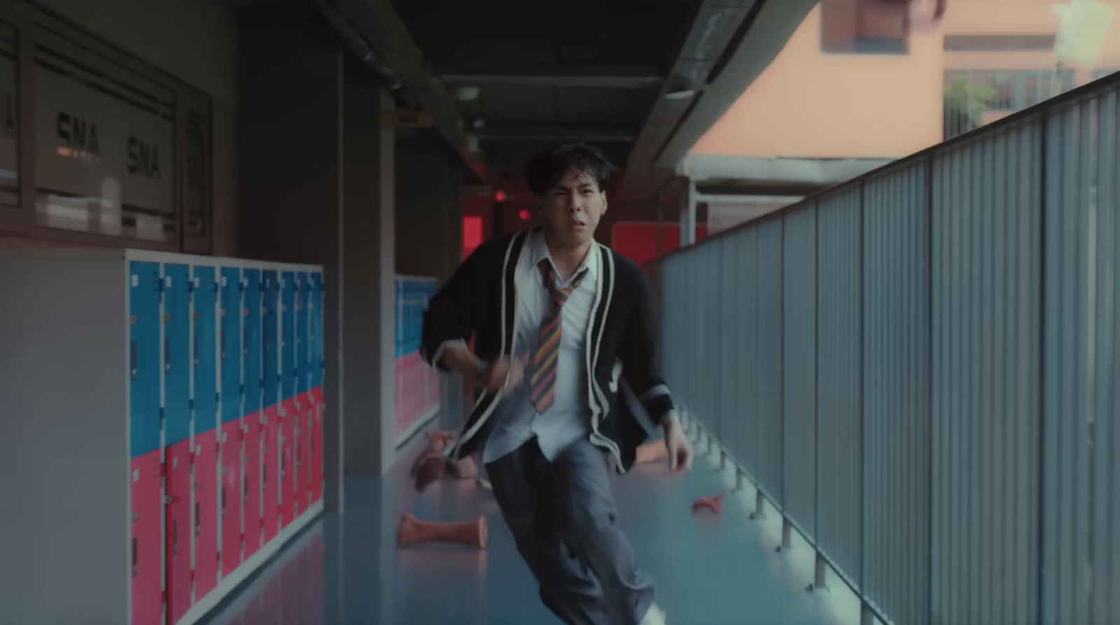 a man in a suit and tie walking down a hallway