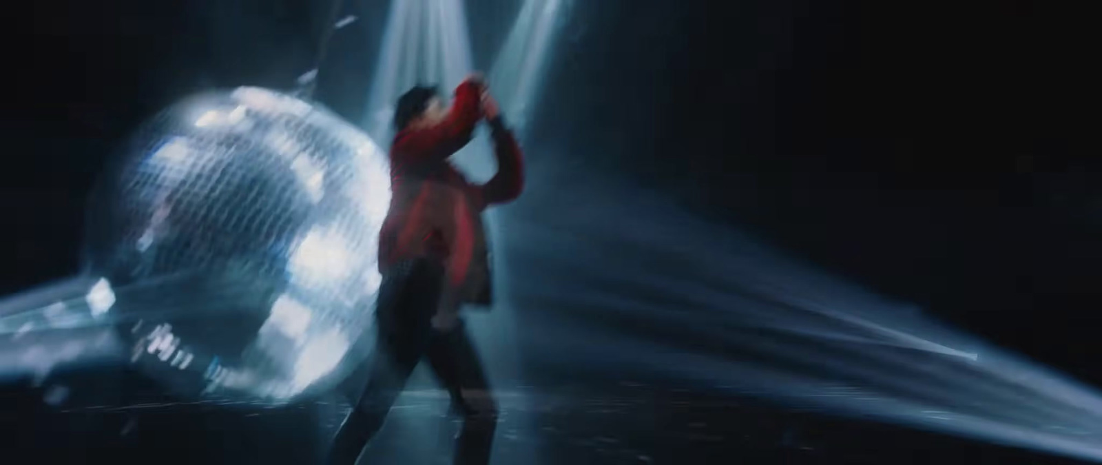 a person standing in front of a disco ball