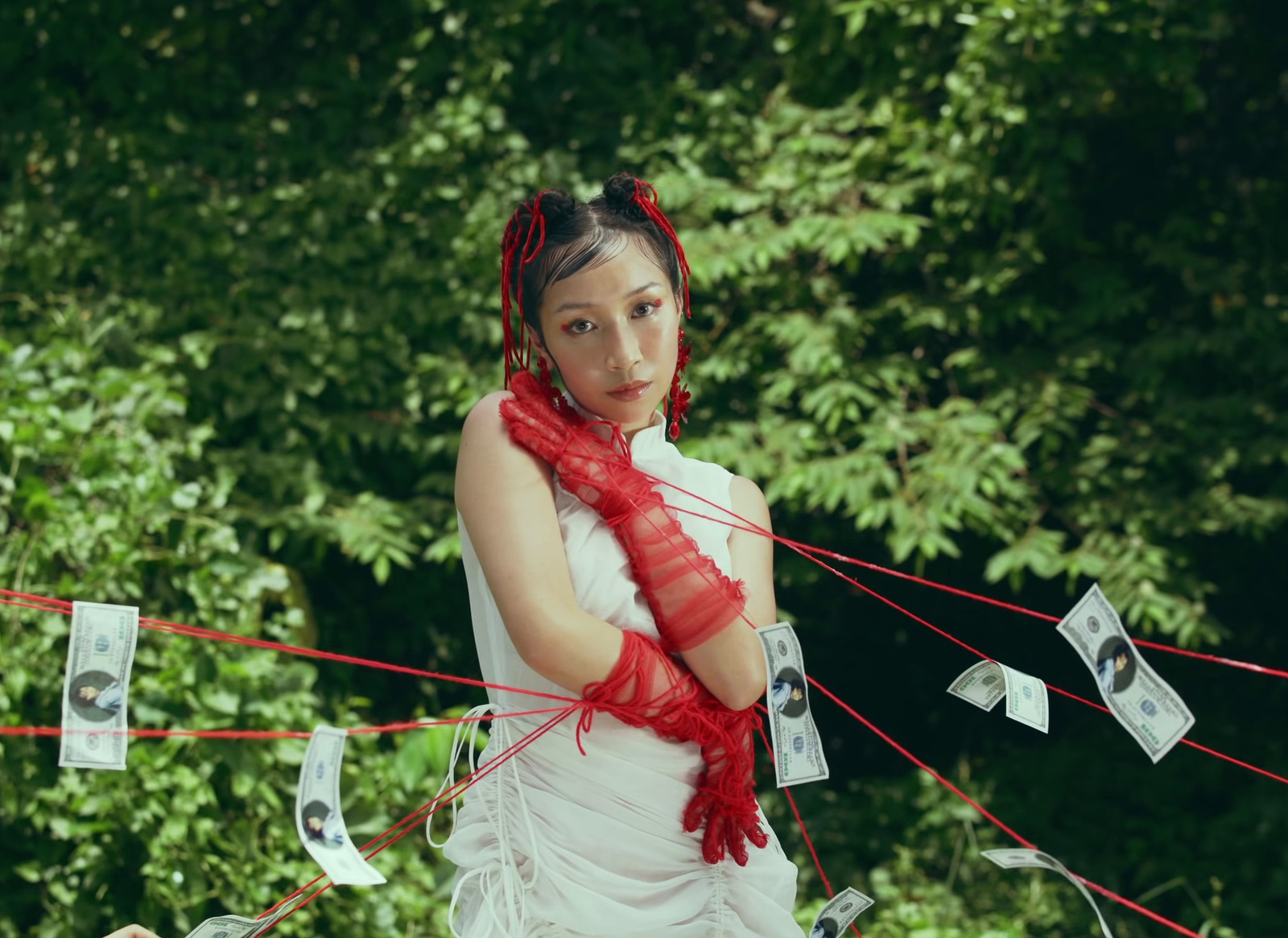 a woman in a white dress and red scarf