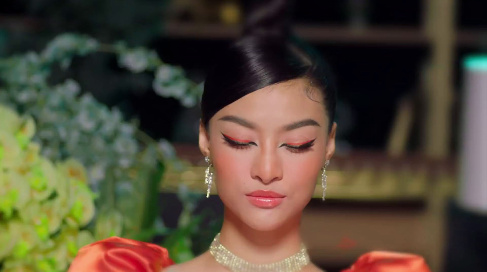 a woman in a red dress with a flower in her hair