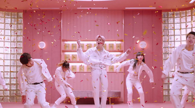 a group of people standing on top of a pink floor