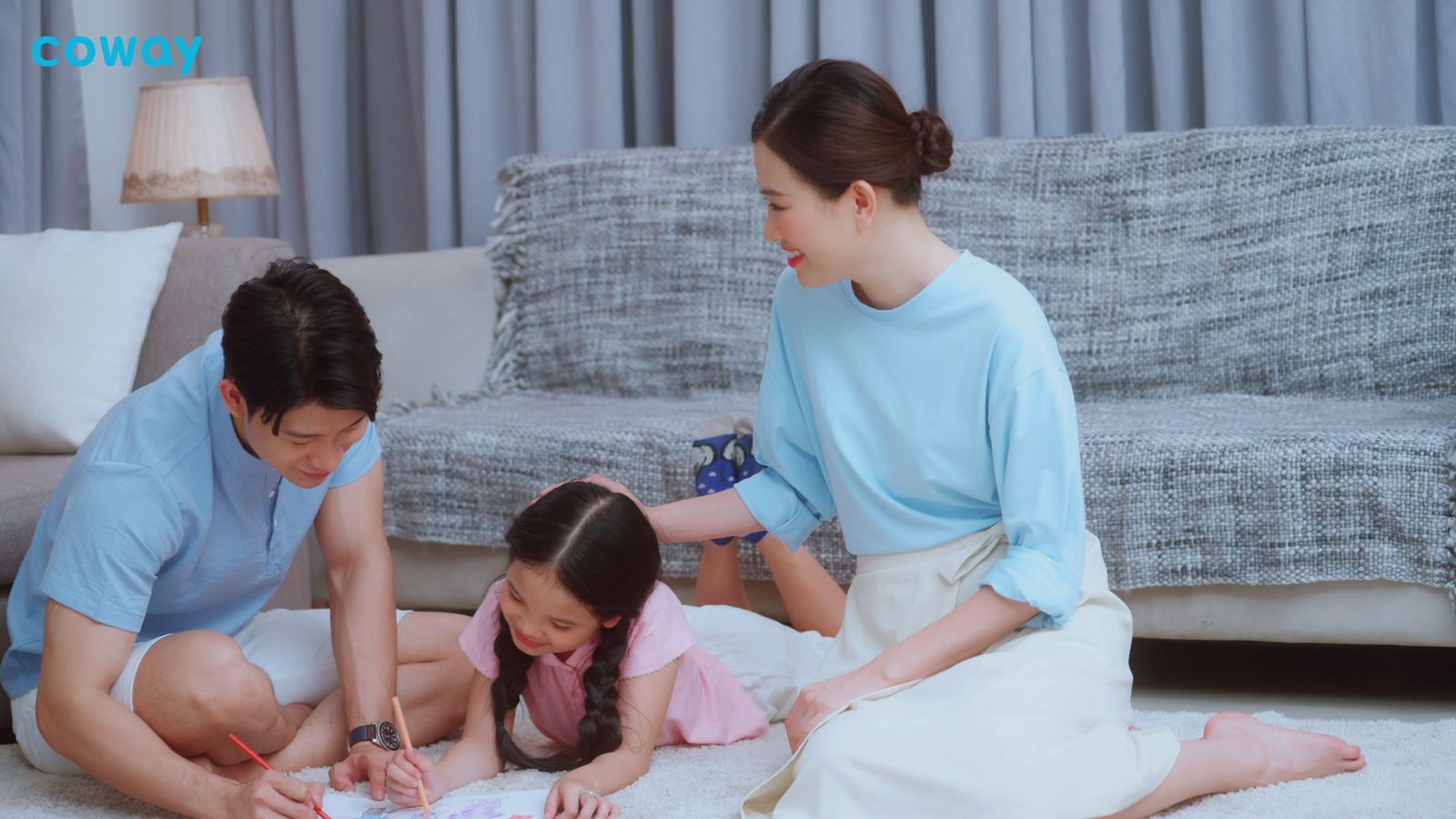 a woman and two children are sitting on the floor