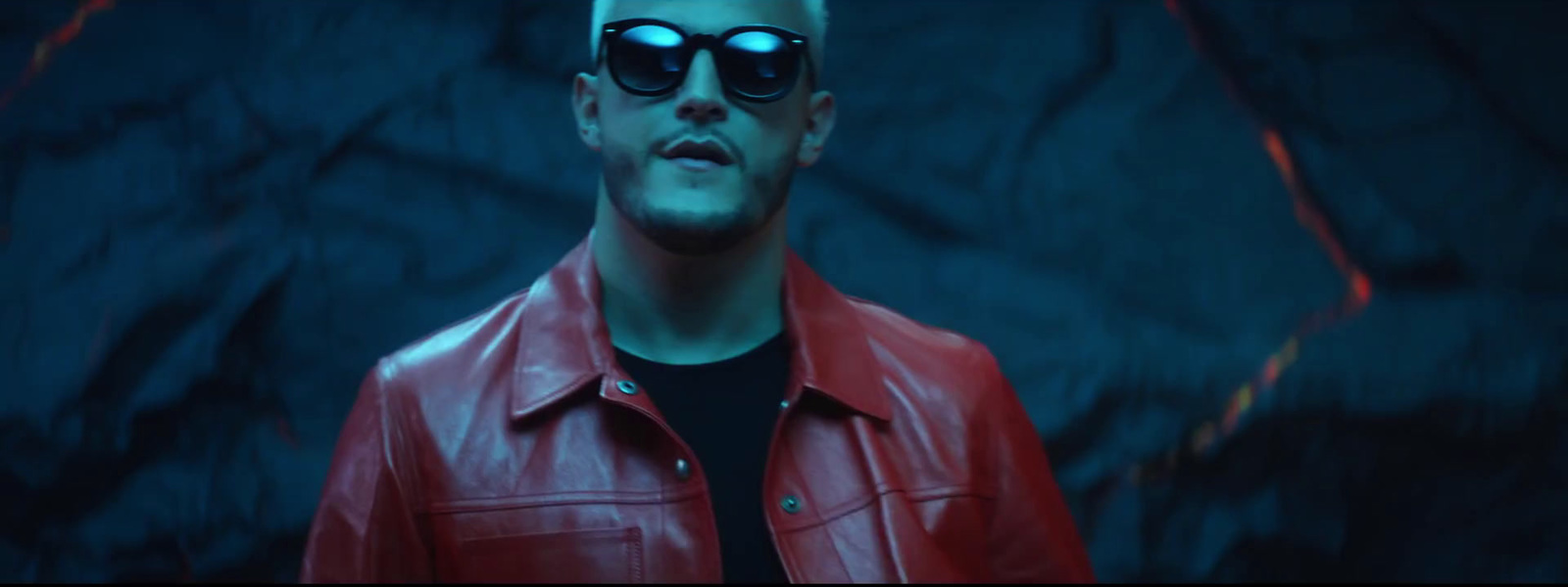 a man in a red leather jacket and sunglasses