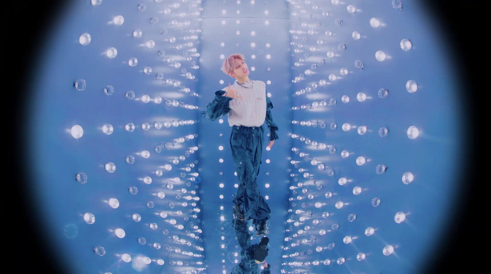 a woman standing in front of a wall of bubbles