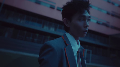 a man in a suit and tie standing in front of a building