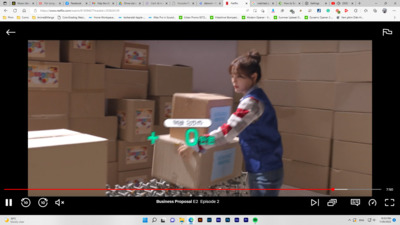 a young boy standing in front of a cardboard box