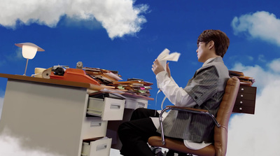 a man sitting at a desk with a lot of papers