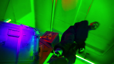 a man standing in a room with green and purple lights