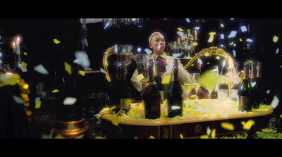 a man standing in front of a table filled with bottles of wine