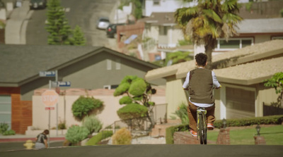 a person riding a bike down a street