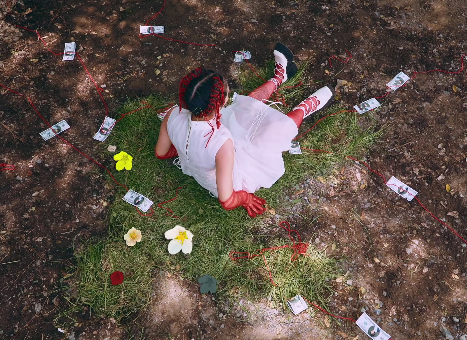 a woman in a white dress laying on the ground