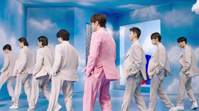 a man in a pink suit and white shoes