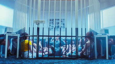 a group of naked people in a caged area