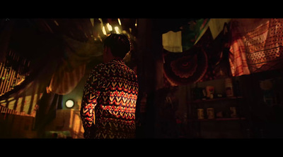 a man standing in front of a shelf in a dark room