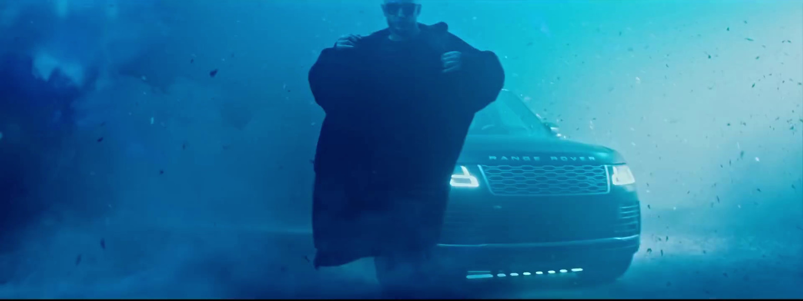 a man standing next to a car under water