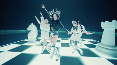 a group of women dancing on a checkered floor