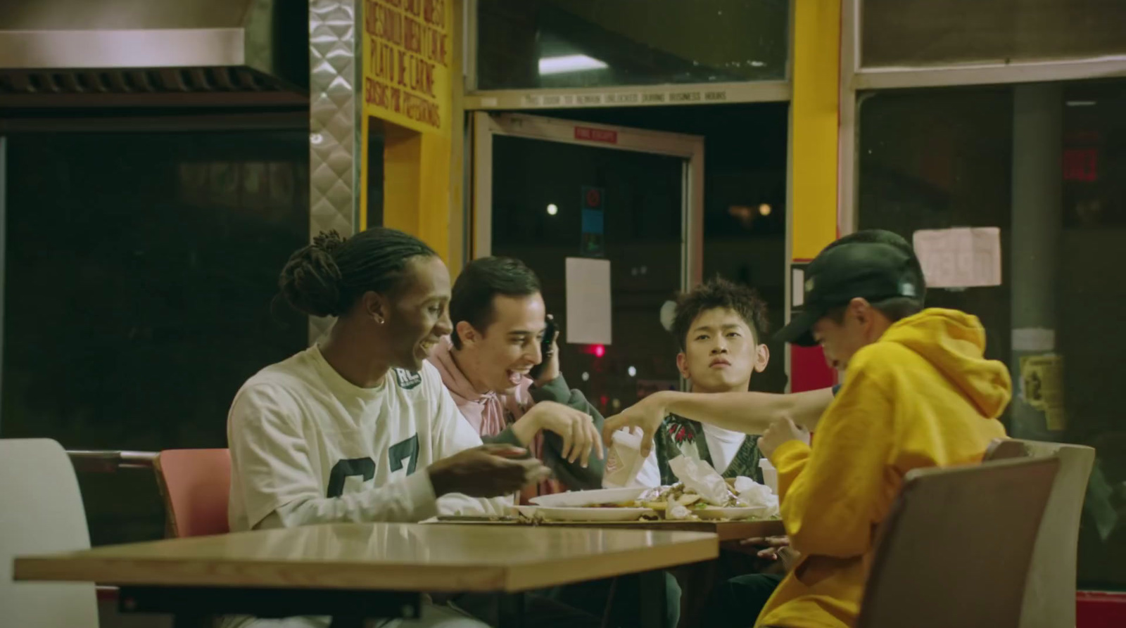 a group of people sitting at a table eating food