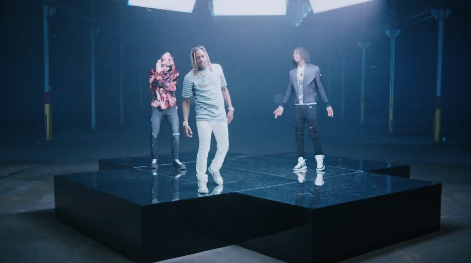 a group of people standing on top of a black table