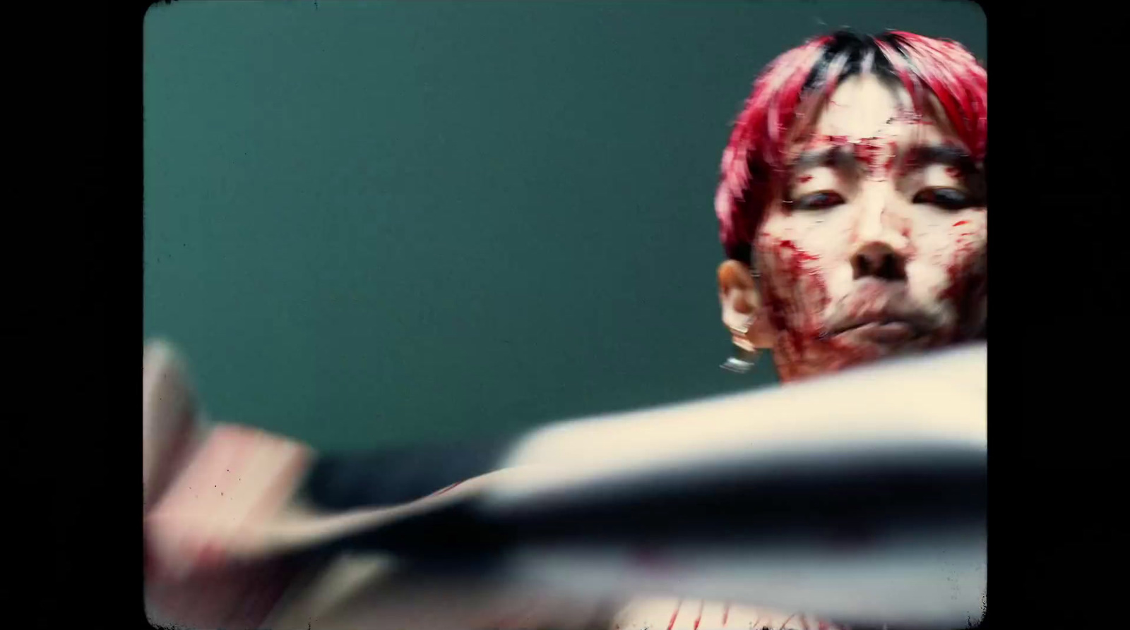 a woman with blood on her face holding a baseball bat