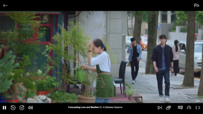 a group of people walking down a street next to trees