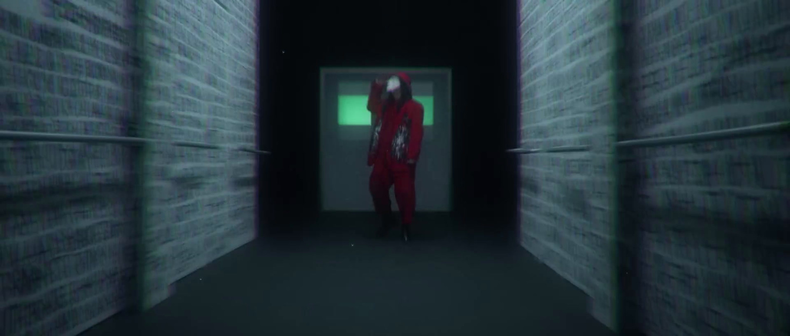 a person in a red suit standing in a dark hallway