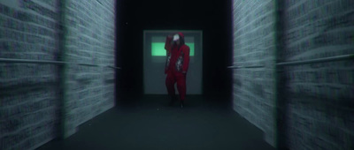 a person in a red suit standing in a dark hallway