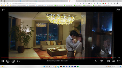 a man and woman standing in front of a chandelier