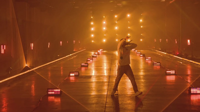 a man standing on top of a stage holding a microphone