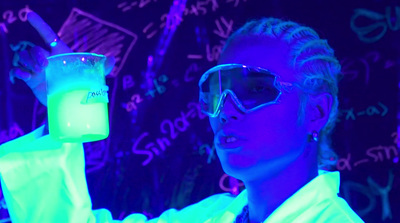 a woman in a lab coat holding a glass of liquid