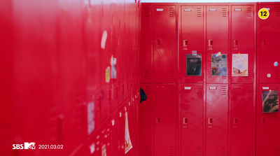 a row of red lockers with pictures on them