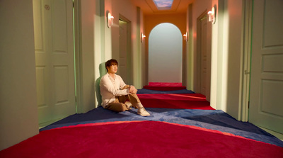 a person sitting on the floor in a hallway