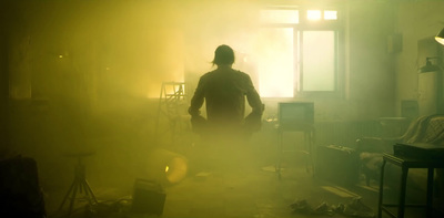 a person standing in a room with a yellow light