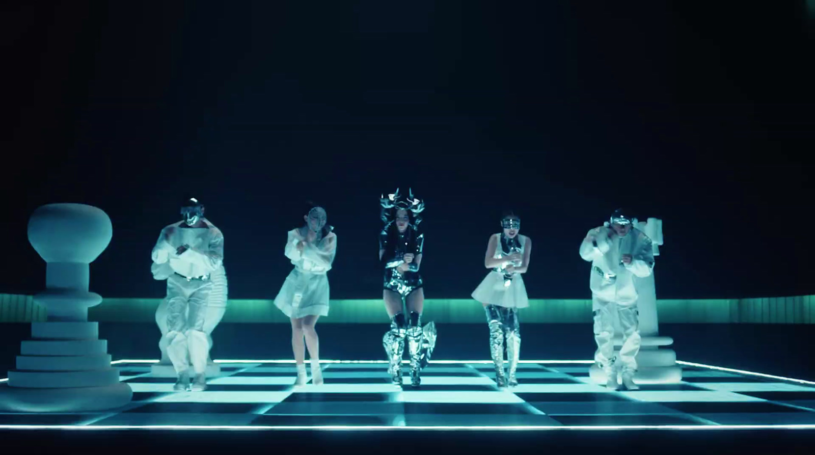 a group of women standing on top of a chess board