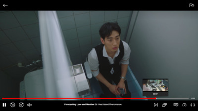 a man sitting on a toilet in a bathroom