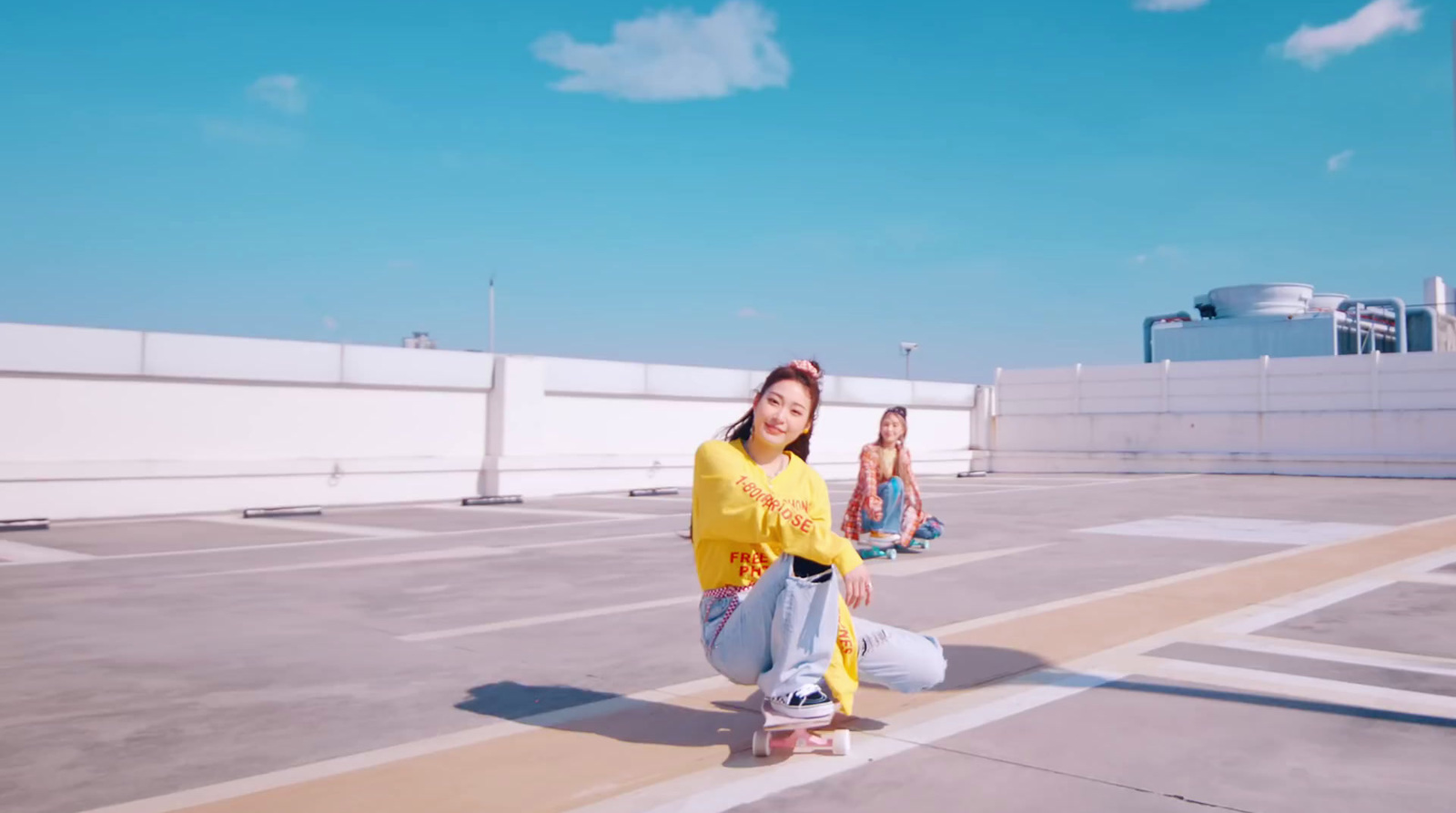 a group of young women sitting on top of a roof