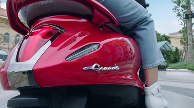 a person riding on the back of a red motorcycle