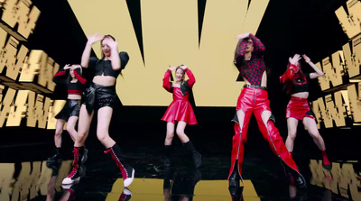 a group of women standing on top of a stage