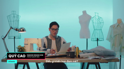 a man sitting at a table working on a computer